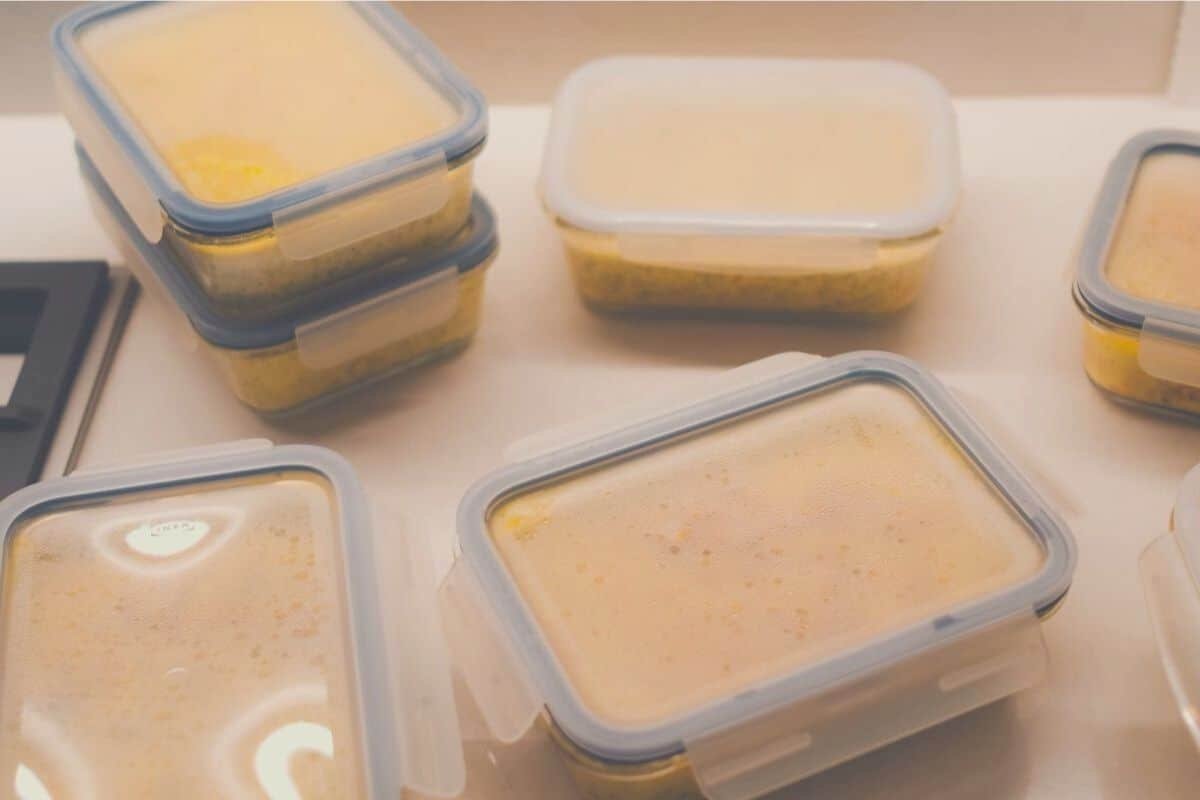 A collection of tupperware containers filled with liquid food