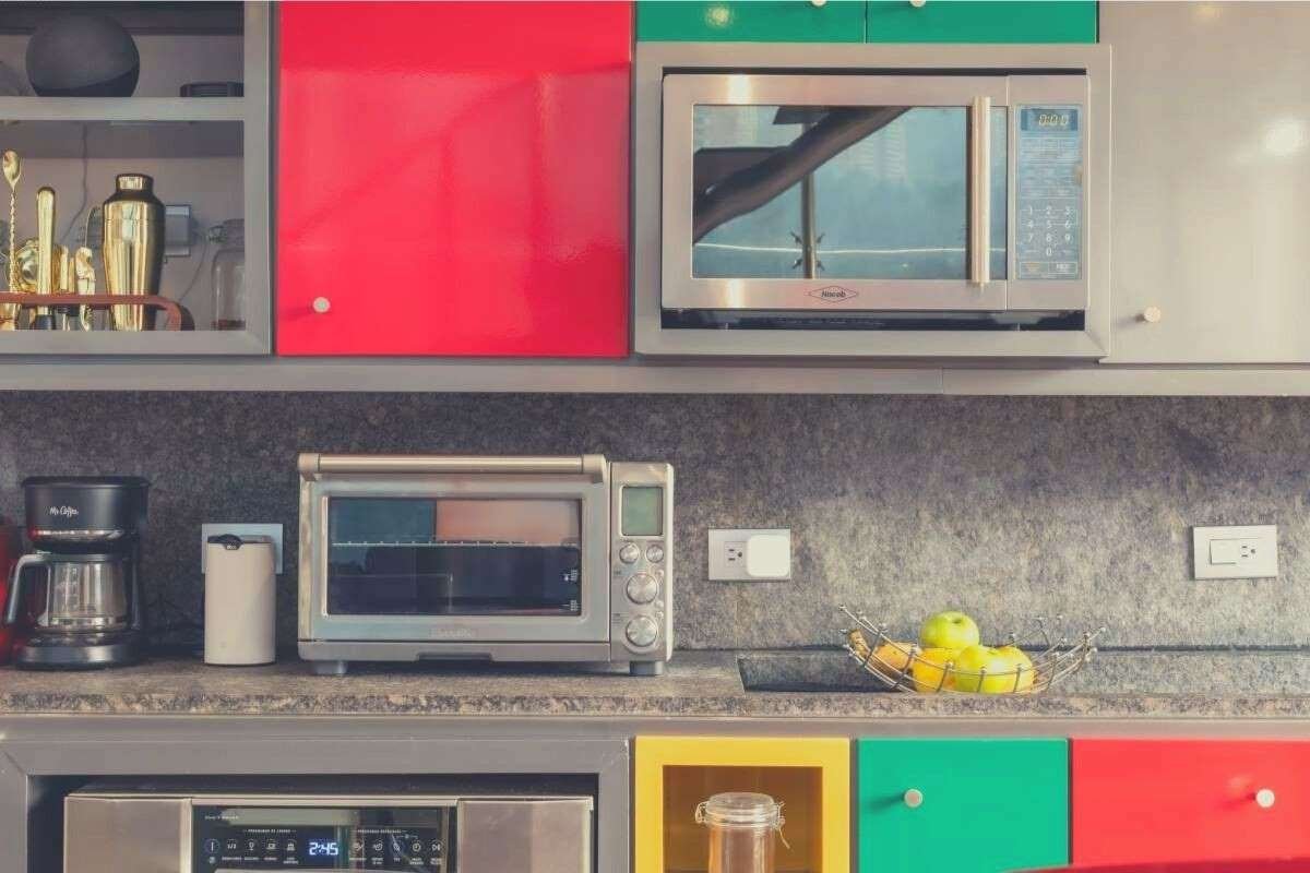 A colorful kitchen featuring a smart oven, main oven and microwave