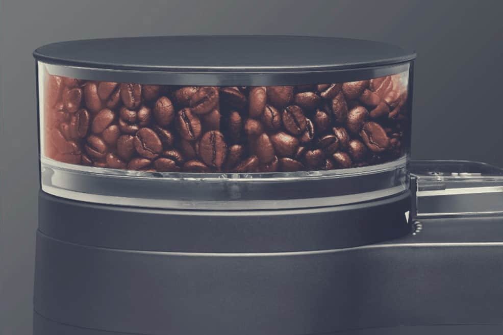 A close up of a coffee machine bean hopper
