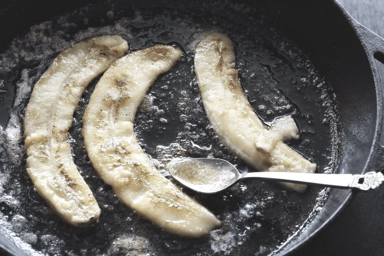 bananas frying in a cast iron pan