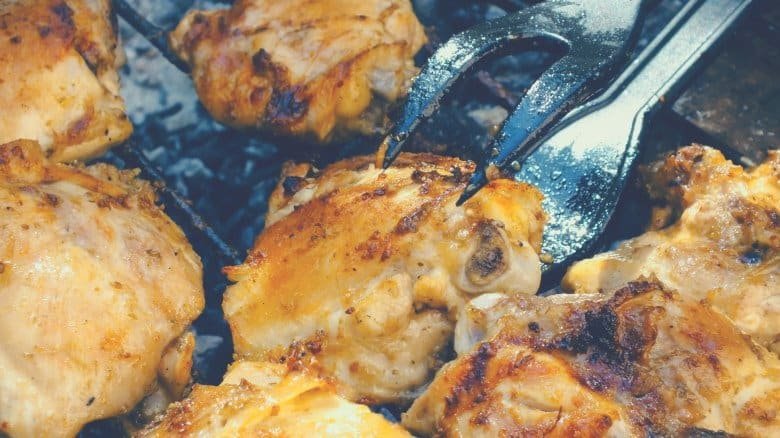 chicken being cooked on a barbecue grill