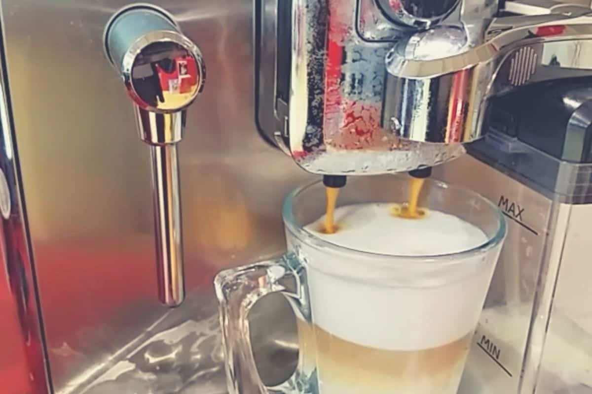 a close up shot of the Gaggia Accademia producing a cappuccino coffee