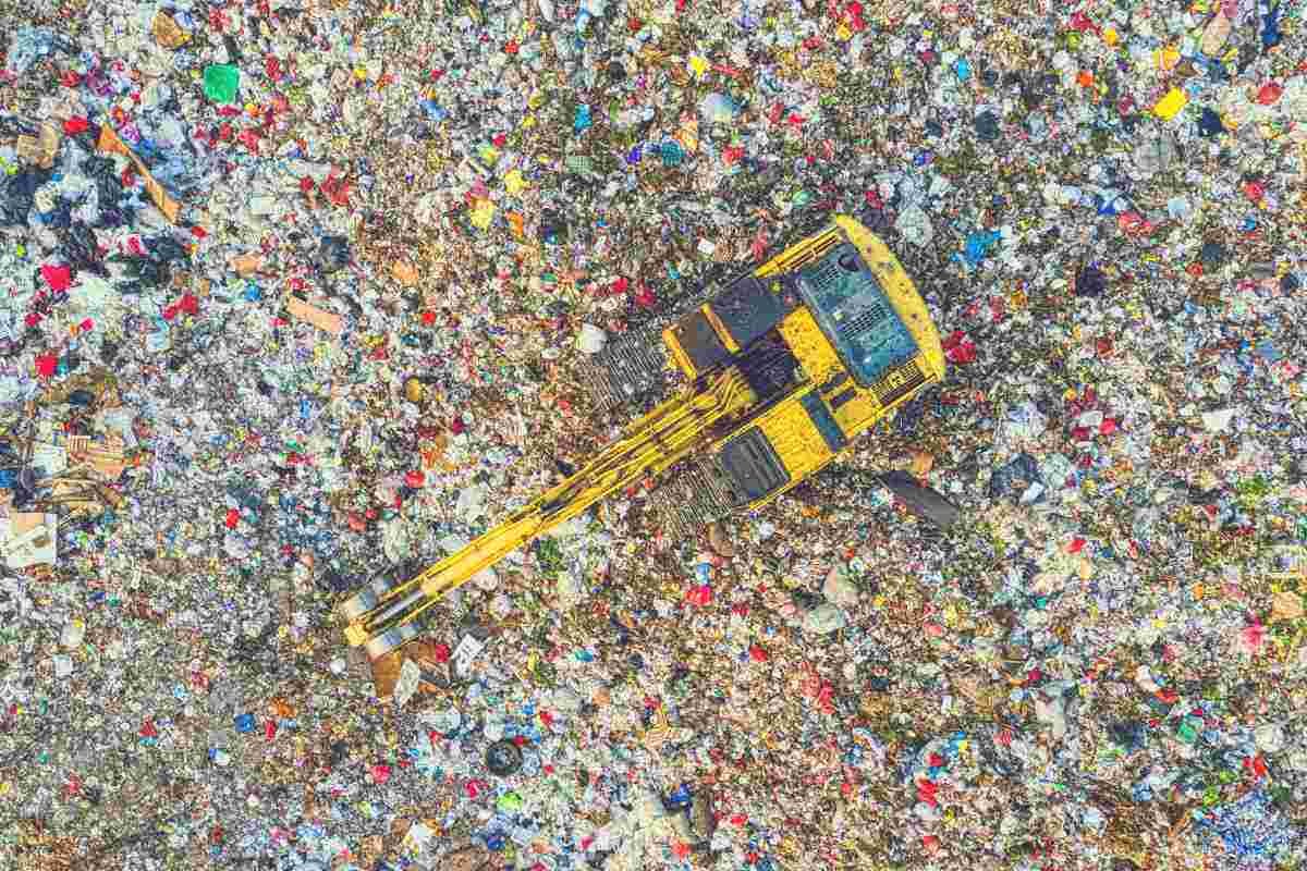 An overhead shot of a digger working at a landfill site