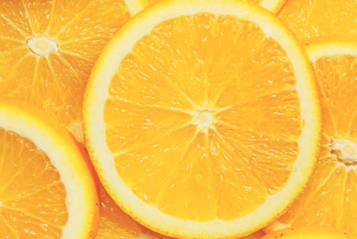 An extreme close up of a pile of sliced oranges