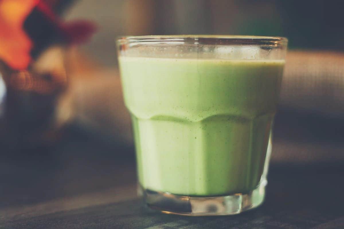 A close up shot of a glass full of celery juice