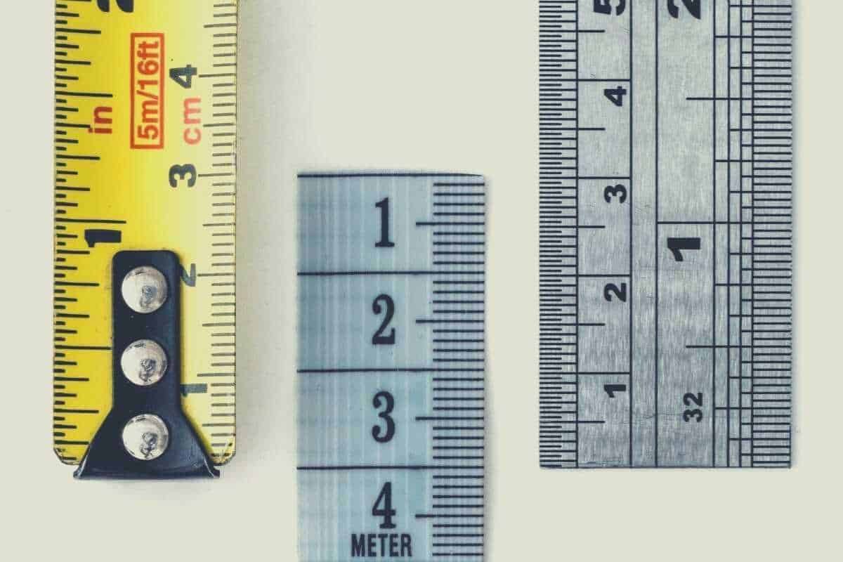 A top down view of three extended tape measures