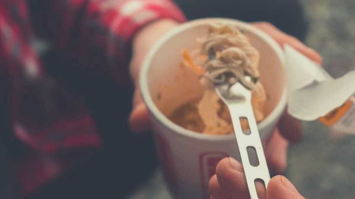 A picture of someone eating a Cup Noodle with a spoon
